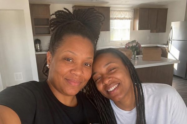 Two women sharing morning coffee in their new kitchen