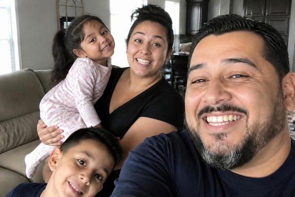 Family of four in their living room